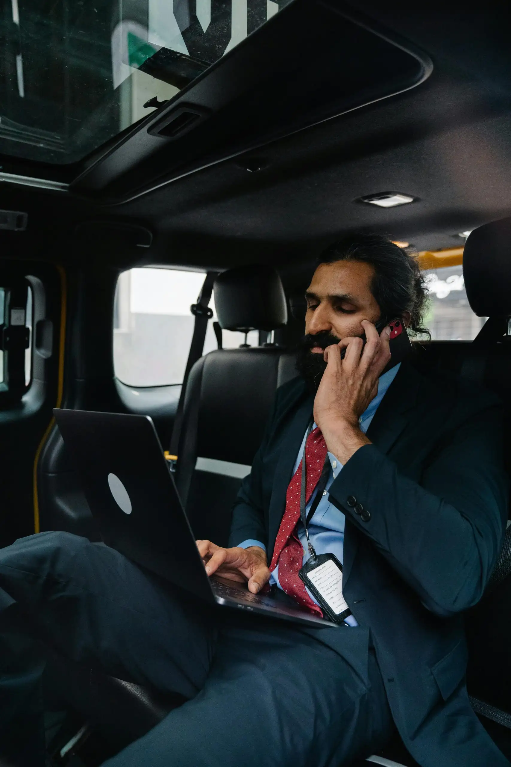 Executive taking a call from the back seat of an electric taxi