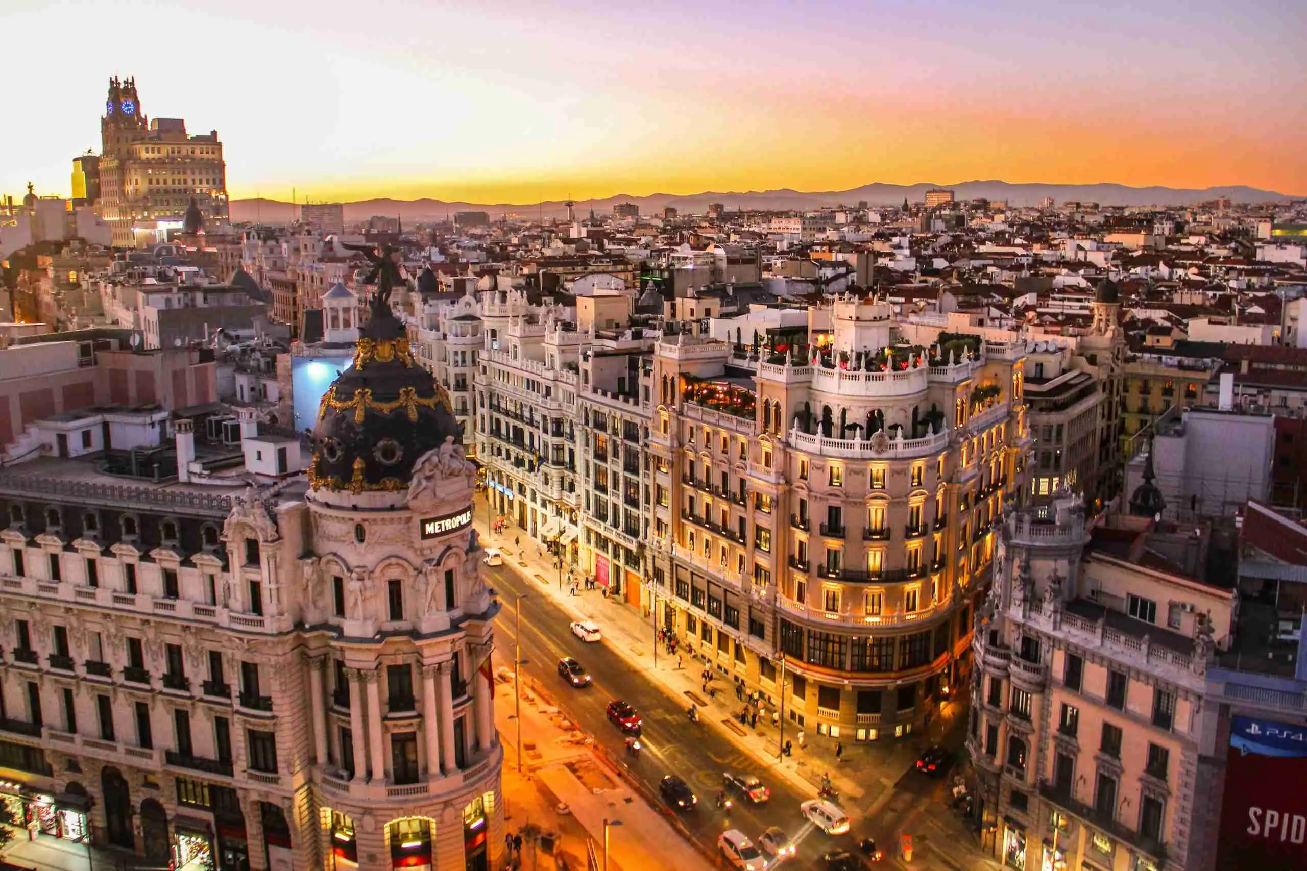 Gran Vía in Madrid at sunset, with traffic
